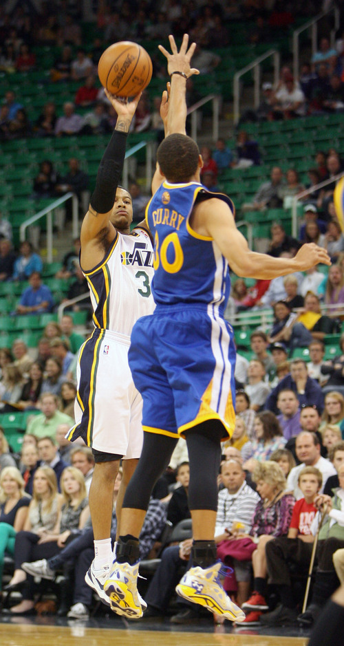 Steve Griffin  |  The Salt Lake Tribune

Utah's Trey Burke makes a three-pointer over Golden State's Seth Curry during first half action in the Jazz versus Golden State preseason NBA basketball game at the EnergySolutions Arena in Salt Lake City, Utah Tuesday, October 8, 2013.