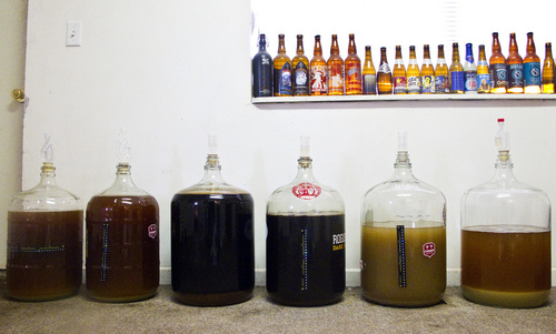 Chris Detrick  |  The Salt Lake Tribune
Homemade batches of beer, from left, rye ipa, coffee stout and Berliner weisse, in various stages of fermentation in five gallon glass carboys.