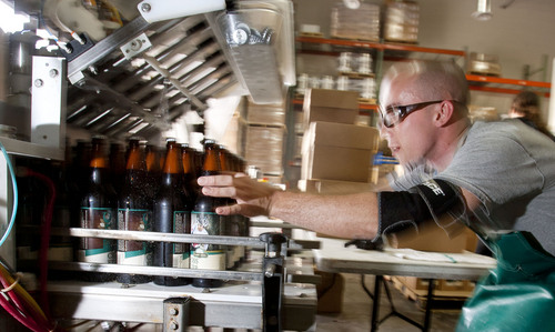 Steve Griffin  |  The Salt Lake Tribune
Epic Brewery packaging supervisor, Nick Cleveland, removes bottles of beer from the bottling line and packages them at the Salt Lake City, Utah brewery on Wednesday.