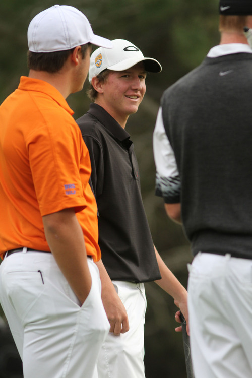 Francisco Kjolseth  |  The Salt Lake Tribune
Kelton Hirsch of Viewmont, center, wins the 5A boys' state golf tournament at the Alpine Country Club in Highland on Tuesday, Oct. 8, 2013 as he is congratulated on by fellow players on the 18th hole.