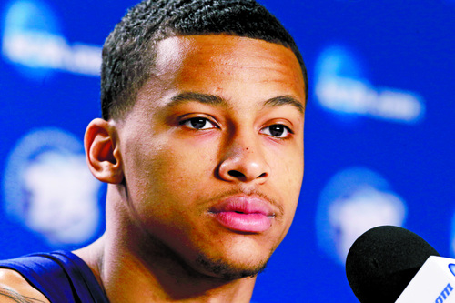 Michigan's Trey Burke listens to a question about their third-round game of the NCAA college basketball tournament during a news conference in Auburn Hills, Mich., Friday March 22, 2013. Memphis will play Michigan State Saturday. (AP Photo/Paul Sancya)