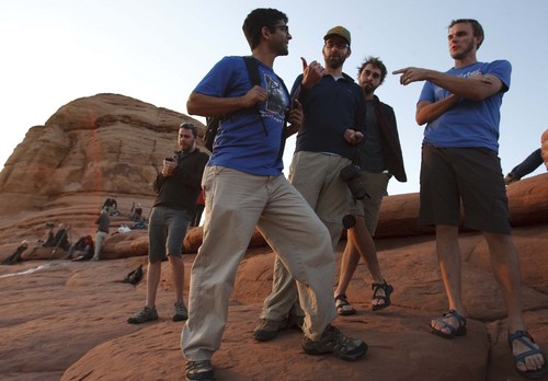 Leah Hogsten | The Salt Lake Tribune
l-r Friends Srini Iyengar, Chris Huot and his brothers Jeremy and Michael from South Dakota came to Utah to bike the White Rim Trail but were spinning their wheels after the park was shut down. Visitors mingled around Delicate Arch to watch the sunset in the newly reopened Arches National Park , Friday, October 11, 2014.Thanks to a $1.7 million payment from Utah taxpayers, the national parks of southern Utah are being exempted from the federal government shutdown just in time for a traditionally busy fall weekend.