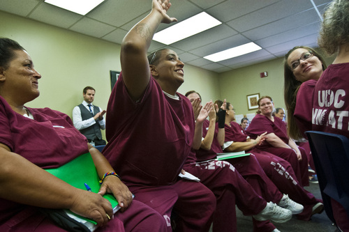 Chris Detrick  |  The Salt Lake Tribune

Julie "Thumper" Bland gets a high-five during a Getting Out by Going In (GOGI) class in the Timpanogos women's facility at Utah State Prison Tuesday August 6, 2013. GOGI is a non-profit organization that helps at-risk and incarcerated individuals make better choices by changing unhealthy patterns of thought and behavior.