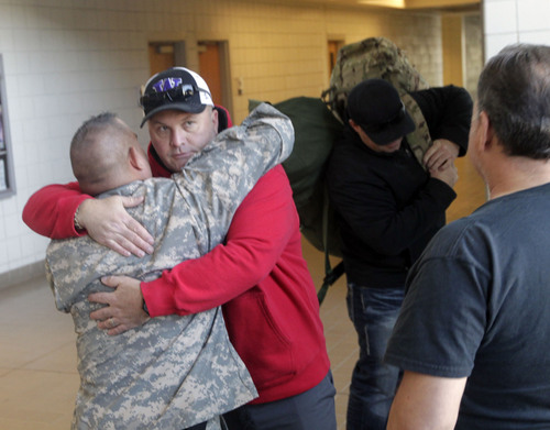 Al Hartmann  |  The Salt Lake Tribune
Thirteen members of the Utah National Guard 115th Engineer Facilities Detachment grab their packs and hug their friends goodbye at Camp Williams Tuesday Oct. 15 for deployment to Afghanistan for one year.