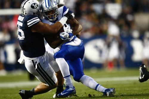 Chris Detrick  |  The Salt Lake Tribune
Brigham Young Cougars defensive lineman Eathyn Manumaleuna (55) tackles Middle Tennessee Blue Raiders running back Jordan Parker (6) during the first half of the game at LaVell Edwards Stadium Friday September 27, 2013. BYU is winning the game 23-10 at halftime.