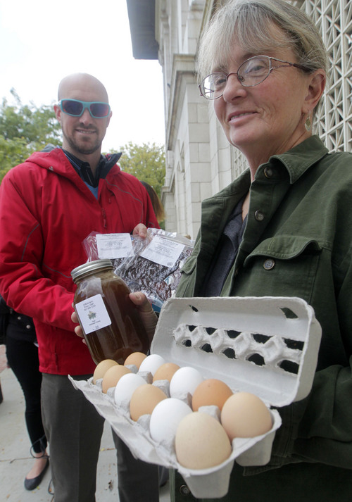 Al Hartmann  |  The Salt Lake Tribune
Julie Clifford of Clifford Family Farm in Provo shows fresh eggs and honey she will sell as a vendor in the just-announced winter market at the Rio Grande Depot Tuesday October 15 in Salt Lake City. Nick Como with the Downtown Alliance, is at left. In a collaborative effort between city and state leaders and the Downtown Alliance, a winter farmers market concept will return to downtown Salt Lake next month. The long-range plan aims to redevelop and revitalize the Rio Grande neighborhood and strengthen Utahís economy to help support Utah ranchers, famers and other small businesses by leveraging the success of the Downtown Farmers Market.