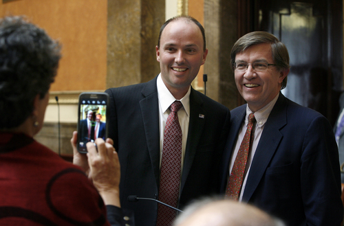 Scott Sommerdorf   |  The Salt Lake Tribune
Rep. Spencer Cox, R-Farview, has his photo made with fellow Rep. Joel Briscoe, right, D-Salt Lake. Taking the photo is Rep. Patrice Arent, D-Salt Lake. Utah lawmakers met in special session about parks funding and the Senate confirmed Cox as the new lieutenant governor, Wednesday, October 16, 2013.