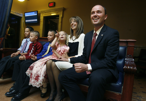 Scott Sommerdorf   |  The Salt Lake Tribune
Rep. Spencer Cox listens with his wife Abby and their four children as he is confirmed by the Utah Senate as Utah's new lieutenant governor, Wednesday, October 16, 2013.