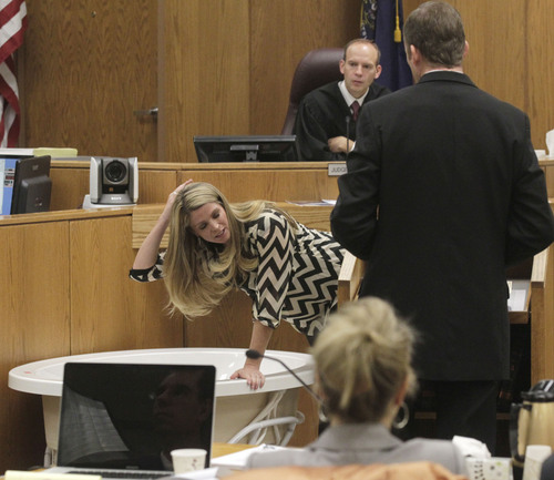 Al Hartmann  |  The Salt Lake Tribune
Neighbor Kristi Daniels leans over a bathtub to describe Michele MacNeill's body position when she was called to the home to help in 2007. The tub was brought into Judge Derek Pullan's 4th District courtroom Friday Ocotber 18. Prosecuter Jared Perkins , right, questions her and Judge Pullan watches above.