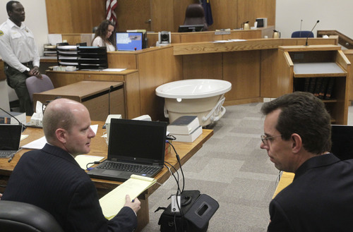 Al Hartmann  |  The Salt Lake Tribune
Prosecuter Chad Grunander, left, and defense attorney Randy Spencer talk  during a recess in Judge Derek Pullan's 4th Distirct Courtroom Friday October 18. A bathtub was brought into court to approximate Michele MacNeill's body position when neighbor Kristi Daniels found Martin MacNeill trying to help her. Martin MacNeill is charged with murder for allegedly killing his wife, Michele, in 2007.