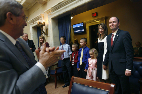 Scott Sommerdorf   |  The Salt Lake Tribune
Newly confirmed as Utah Lt. Governor, Rep. Spencer Cox is applauded by the members of the Senate. Senator David Hinkins, R-Orangeville, is at left as Spencer Cox stands with his with Abby, and their four children, (from left):  Gavin, Adam, Caleb and Emma Kay, Wednesday, October 16, 2013.