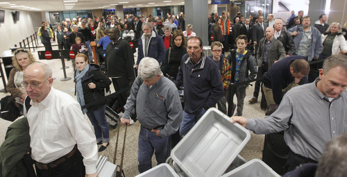 Al Hartmann  |  The Salt Lake Tribune
Fliers at Salt Lake City International Airport, Terminal 2, security checkpoint grab plastic bins for personal carry on items like, shoes, jackets, and backpacks to go through Xray machine Tuesday January 15 at 7:30 a.m.