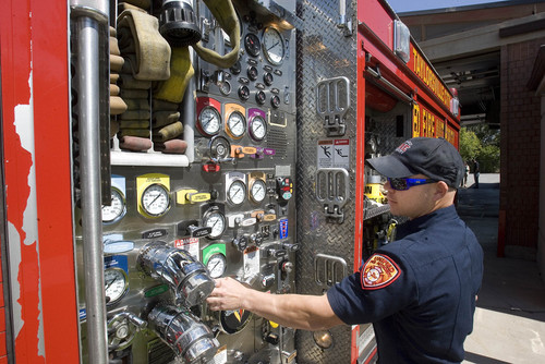 Paul Fraughton   |   The Salt Lake Tribune
Firefighter Adam Halsey, stationed at Taylorsville's Station No. 117, checks gauges on the station's engine.                           
 Monday, September 9, 2013