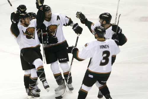Chris Detrick  |  The Salt Lake Tribune
Grizzlies' Jamie MacQueen (17) celebrates his first goal with his teammates during the game at Maverik Center Friday October 18, 2013.