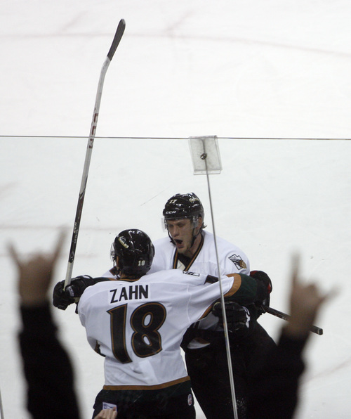 Chris Detrick  |  The Salt Lake Tribune
Grizzlies' Jamie MacQueen (17) celebrates his second goal with Grizzlies' Teigan Zahn (18) during the game at Maverik Center Friday October 18, 2013. The Grizzlies are winning 2-0.