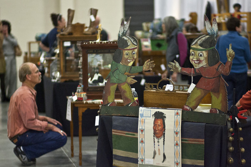 Chris Detrick  |  The Salt Lake Tribune
People look at antiques for sale during the Original Salt Lake Antique Show at the South Towne Exposition Center Saturday October 19, 2013. Dealers from around the country will be selling pottery, heirloom jewelry, textiles, fine art, country store antiques, Native American art and more. The show continues Sunday from noon to 5 p.m.
