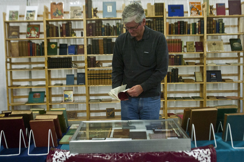 Chris Detrick  |  The Salt Lake Tribune
Craig Smith, of Salt Lake City, looks at antique books during the Original Salt Lake Antique Show at the South Towne Exposition Center Saturday October 19, 2013. Dealers from around the country will be selling pottery, heirloom jewelry, textiles, fine art, country store antiques, Native American art and more. The show continues Sunday from noon to 5 p.m.