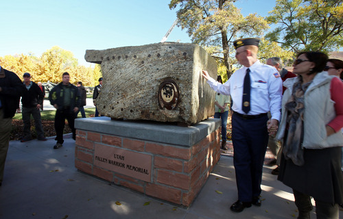 Francisco Kjolseth  |  The Salt Lake Tribune
The Utah Fallen Warrior Memorial is dedicated at Fort Douglas on the University of Utah campus on Monday, Oct. 21, 2013 as people get a closer look and feel for the piece. The big chunk of foundation from the World Trade Center, which is the key featured in the memorial, has been on a statewide tour for several weeks before its final resting place at the Fort Douglas Museum.