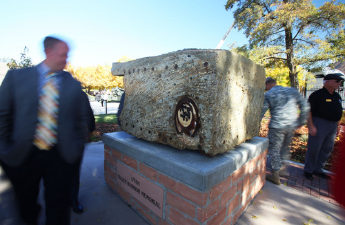 Francisco Kjolseth  |  The Salt Lake Tribune
The Utah Fallen Warrior Memorial is dedicated at Fort Douglas on the University of Utah campus on Monday, Oct. 21, 2013 as people get a closer look and feel for the piece. The big chunk of foundation from the World Trade Center, which is the key featured in the memorial, has been on a statewide tour for several weeks before its final resting place at the Fort Douglas Museum.