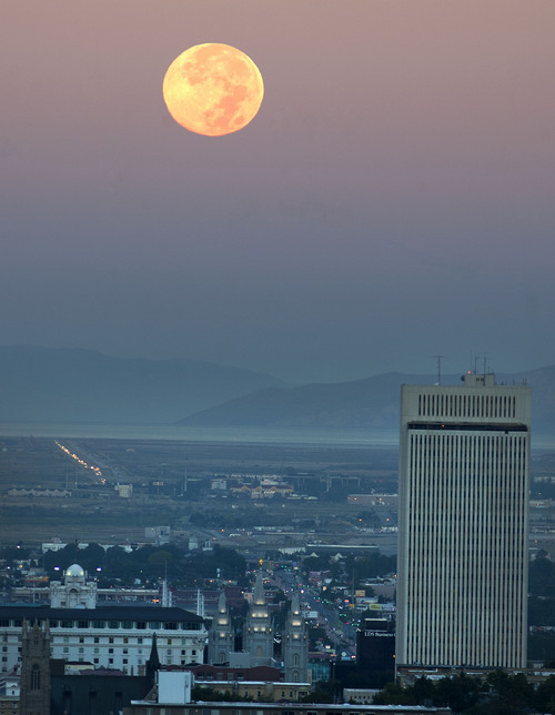 Steve Griffin  |  The Salt Lake Tribune
The moon sets behind the Salt Lake City skyline on Thursday.