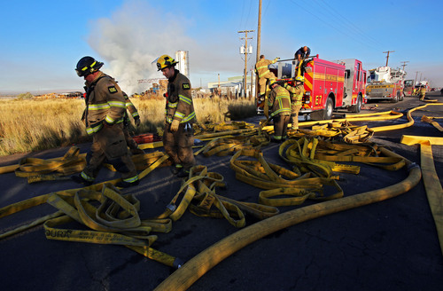 Francisco Kjolseth  |  The Salt Lake Tribune
Salt Lake City Fire engine 7 crews pack up the hoses following a two-alarm blaze Wednesday morning on a rural lot along the west Salt Lake City and Magna city line .