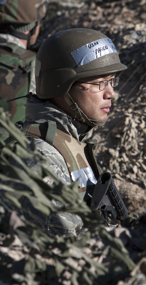 Steve Griffin  |  The Salt Lake Tribune

Aaron Hwang, a members of the 729th Air Control Squadron, keeps watch from a bunker position during a wartime exercise mission at Hill Air Force Base near Ogden, Utah Thursday, October 24, 2013. The squadron provides communications and controls airspace and was simulating that mission in a bare base, hostile environment set up on the north end of the airbase.