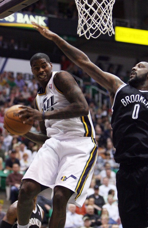 Kim Raff  |  The Salt Lake Tribune
(left) Utah Jazz power forward Marvin Williams (2) rebounds the ball as (right) Brooklyn Nets center Andray Blatche (0) defends during the second half at EnergySolutions Arena in Salt Lake City on March 30, 2013.  The Jazz won the game 116-107.
