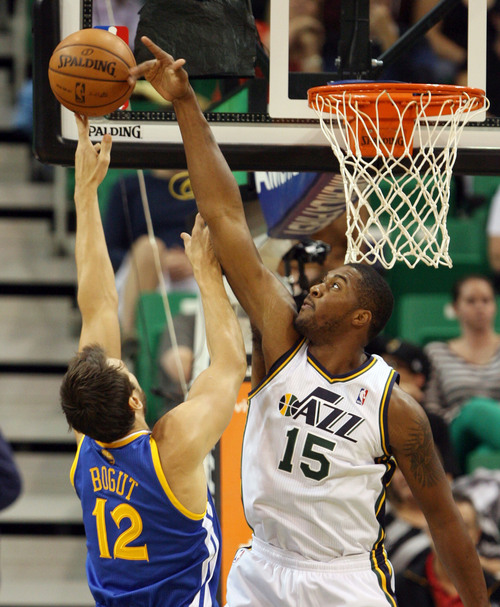 Steve Griffin  |  The Salt Lake Tribune

Utah's Derrick Favors blocks the shot of Golden State's Andrew Bogut during first half action in the Jazz versus Golden State preseason NBA basketball game at EnergySolutions Arena in Salt Lake City, Utah Tuesday, October 8, 2013.