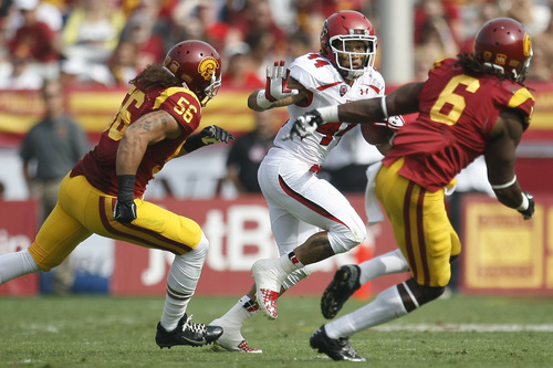 Chris Detrick  |  The Salt Lake Tribune
Utah Utes running back Lucky Radley (44) runs past USC Trojans linebacker Anthony Sarao (56) and USC Trojans safety Josh Shaw (6) during the first half game at the The Los Angeles Memorial Coliseum Saturday October 26, 2013. USC is winning the game 16-3.