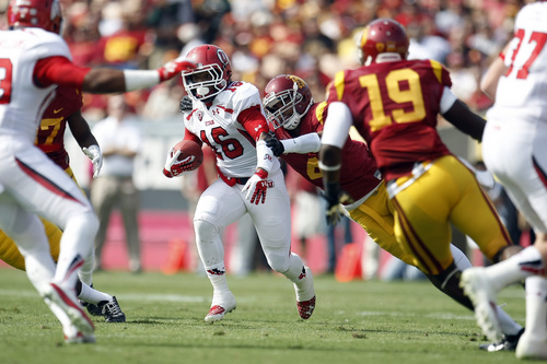 Chris Detrick  |  The Salt Lake Tribune
Utah Utes wide receiver Geoff Norwood (16) is tackled by USC Trojans cornerback Torin Harris (4) during the first half game at the The Los Angeles Memorial Coliseum Saturday October 26, 2013. USC is winning the game 16-3.