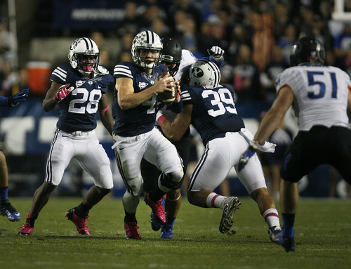 Scott Sommerdorf   |  The Salt Lake Tribune
BYU QB Taysom Hill scrambles as he looks for a receiver during first half play. BYU held a 24-3 lead over Boise State, Friday, October 25, 2013.
