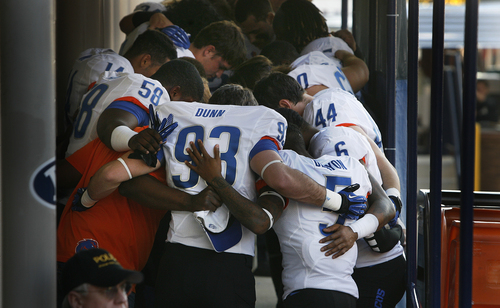 Scott Sommerdorf   |  The Salt Lake Tribune
Boise State players including Boise State Broncos tight end Brennyn Dunn (93) and Boise State Broncos cornerback Donte Deayon (5)pause outside their lockerroom for a brief prayer after their pre-game wlak-through, Friday, October 25, 2013.