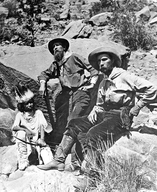 Photo Courtesy Utah State Historical Society

Painter Thomas Moran and New York Times writer J.E. Colburn in Southeastern Utah with a young Paiute child in 1873 while traveling with John Wesley Powell and his expedition. J.E. Colburn was travelling with the survey expedition to record his impressions of the southwest for a chapter in William Cullen Bryan's Picturesque American. Thomas Moran's vision of the Western landscape was critical to the creation of Yellowstone National Park. His artwork was presented to members of Congress by park proponents. These powerful images of Yellowstone fired the imagination and helped inspire Congress to establish the National Park System in 1916.