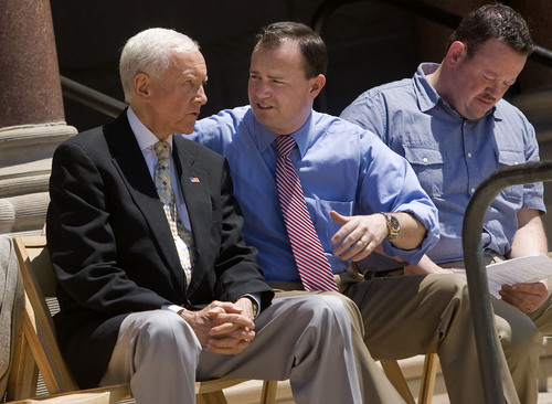 Al Hartmann  |  The Salt Lake Tribune
Utah Senators Orrin Hatch, left and Mike Lee talk before a rally for a balanced budget amendment at the Salt Lake City-County Building Friday July 8.  State Representative Karl Wimmer at right.