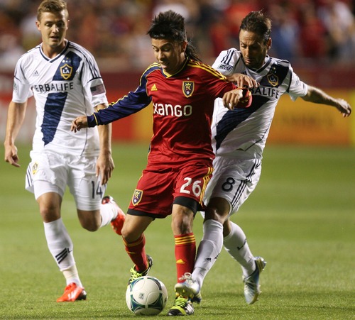 Kim Raff  |  The Salt Lake Tribune
(left) Real Salt Lake midfielder Sebastian Velasquez (26) tries to hang onto the ball as (right) Los Angeles Galaxy midfielder Marcelo Sarvas (8) defends during the second half at Rio Tinto Stadium in Salt Lake City on June 8, 2013.  Real went on to win the game 3-1.
