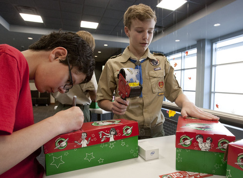 Steve Griffin  |  The Salt Lake Tribune


Jared Goodell, 13, from Sandy Utah, prepares boxes during an Operation Christmas Child packing party at Jordan Commons in Sandy, Utah Sunday, October 27, 2013. The event was part of his Eagle Scout Project. Gift-filled shoe-boxes were packed by valley residents for needy kids overseas this Christmas. Operation Christmas Child helps make the holiday a little brighter for children in more than 100 countries. About 40 volunteers packed over 100 boxes during the event.