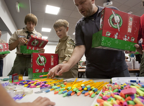 Steve Griffin  |  The Salt Lake Tribune


Boy Scouts and other volunteers pack boxes as Jared Goodell, 13, from Sandy Utah, hosted an Operation Christmas Child packing party as his Eagle Scout Project at the Jordan Commons in Sandy, Utah Sunday, October 27, 2013. Gift-filled shoe-boxes were packed by valley residents for needy kids overseas this Christmas. Operation Christmas Child helps make the holiday a little brighter for children in more than 100 countries. About 40 volunteers packed over 100 boxes during the event.