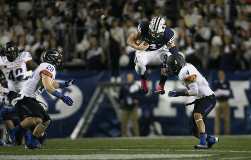 Scott Sommerdorf   |  The Salt Lake Tribune
BYU QB Taysom Hill inexplicably jumps near the end of a scramble as he was about to be sandwiched by Boise State Broncos safety Dillon Lukehart (28)and Boise State Broncos safety Darian Thompson (4). BYU held a 24-3 lead over Boise State at the half, Friday, October 25, 2013.