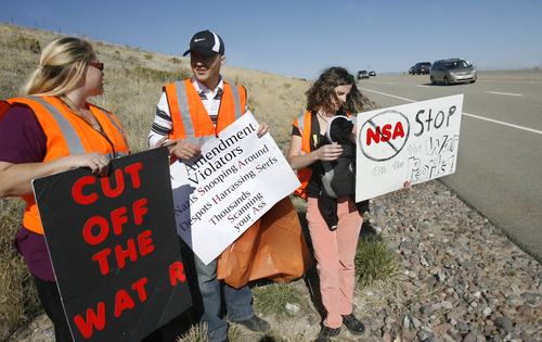 Scott Sommerdorf   |   The Salt Lake Tribune
Lorina Potter, left, and Shan and Amy Morris talk while the group Restore the Fourth (amendment) is having its first cleanup on Redwood Road in front of the new NSA Data Center. The group adopted the road, using the cleanup as a Rally Against Mass Surveillance on Saturday.