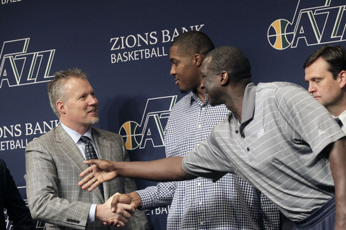 Al Hartmann  |  The Salt Lake Tribune
Utah jazz owner Greg Miller, left, shakes hands with power forward Derrick Favors on his new multi-year contract extension during a press conference Monday October 28, 2013 in Salt Lake City. Jazz coach Tyrone Corbin, is at right.