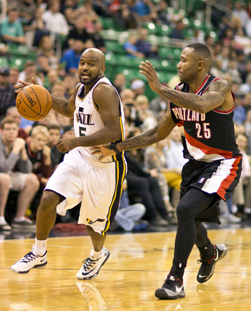 Lennie Mahler  |  The Salt Lake Tribune
Jazz guard John Lucas drives to the basket guarded by Portland's Mo Williams as the Utah Jazz face the Portland Trailblazers at EnergySolutions Arena on Wednesday, Oct. 16, 2013. Portland beat Utah 99-92.