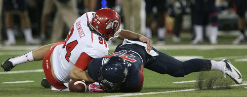 Steve Griffin  |  The Salt Lake Tribune

Arizona Wildcats wide receiver Johnny Jackson (30) fumbles a punt as Utah Utes long snapper Chase Dominguez (94) tackles him during second half action in the University of Utah versus University of Arizona football game at Arizona Stadium in Tucson, Ariz., Saturday, October 19, 2013. Jackson was able to recover the fumble.