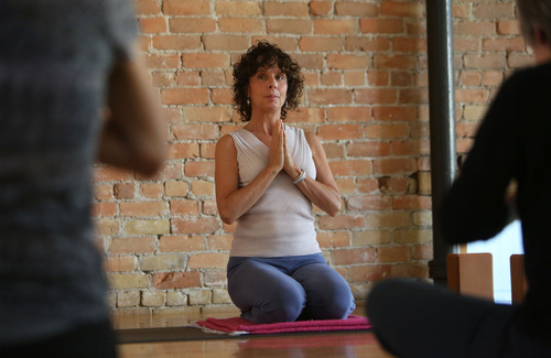 Francisco Kjolseth  |  The Salt Lake Tribune
Annie King, a 55-year-old yoga teacher and CranioSacral therapist in Salt Lake City who needs a hip replacement, teaches her last class at Avenues Yoga before a possible surgery. King may wait until after she can buy insurance through the marketplace. Currently she has no insurance and if she wants or needs to get the surgery before 2014 she will need $14,800 in cash to pay the hospital upfront.
