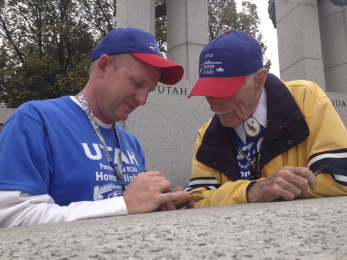 Thomas Burr  |  The Salt Lake Tribune
Brent Byington of Reno, Nev., jots down contact information from World War II veteran Creed Evans of St. George during a visit to the war's memorial in Washington on Wednesday. Evans, a medical doctor, was one of 32 veterans to make Utah's first Honor Flight in which donors pay for the former soldiers to tour the nation's capital.
