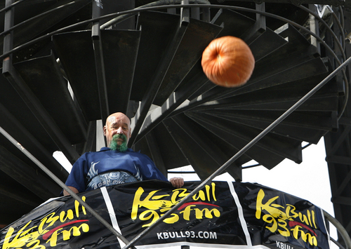 Scott Sommerdorf   |  The Salt Lake Tribune
Pumpkin-drop winner Steve Green watches as pumpkins dropped by other competitors speed past him as he stands halfway up the Trolly Square water tower. A local radio station sponsored a contest where 25 contestants dropped Halloween pumpkins off Trolley Square's Water Tower, aiming for a car's open sunroof some 80 feet below. Contestants dressed in their Halloween best and later joined in for a multi-pumpkin grand finale, Thursday, October 31, 2013.