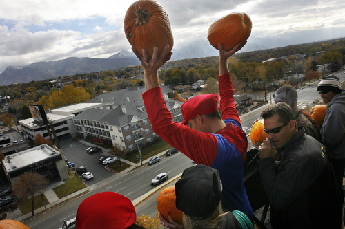 Scott Sommerdorf   |  The Salt Lake Tribune
Contestants queue up for the grand finale where they all threw pumpkins of the top of Trolley Square's Water Tower, aiming for a car's open sunroof some 80 feet below, Thursday, October 31, 2013.