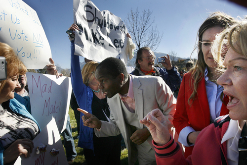 Scott Sommerdorf   |  The Salt Lake Tribune
Rally organizer Amelia Powers, second from right, and other Mike Lee supporters confronted anti-Lee demonstrators who spoke out from the fringes of the rally Saturday in South Jordan. The man at center chastised them, saying, "The last time I checked it was Obama who shut down the government!"