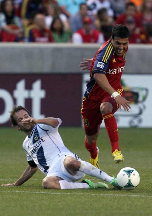 Kim Raff  |  The Salt Lake Tribune
Real Salt Lake midfielder Javier Morales (11) jumps over the legs of Los Angeles Galaxy forward Mike Magee (18) as he tries for a slide tackle during the first half at Rio Tinto in Sandy on April 27, 2013.