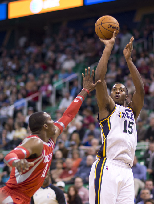 Lennie Mahler  |  The Salt Lake Tribune
Jazz forward Derrick Favors shoots over Rockets center Dwight Howard in the first half of a game against the Houston Rockets on Saturday, Nov. 2, 2013, at EnergySolutions Arena in Salt Lake City.