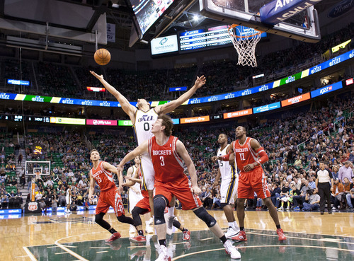 Lennie Mahler  |  The Salt Lake Tribune
Jazz center Enes Kanter reaches to corral the ball in the first half of a game against the Houston Rockets on Saturday, Nov. 2, 2013, at EnergySolutions Arena in Salt Lake City.